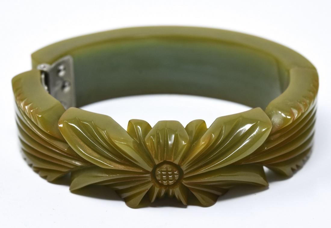 Vintage Hand Carved Green Bakelite Bracelet: Vintage Hand Carved Green Bakelite Bracelet. Clamper or hinged bangle bracelet. Measures 2 inches across the opening.