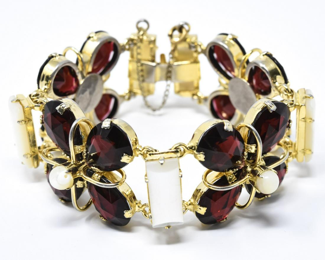 Vintage C 1955 Mother of Pearl Rhinestone Bracelet: Vintage C 1955 Mother of Pearl & Garnet Tone Rhinestone Bracelet w Safety Chain. Prong Set stones and panels. Measures 7.75 inches in length.