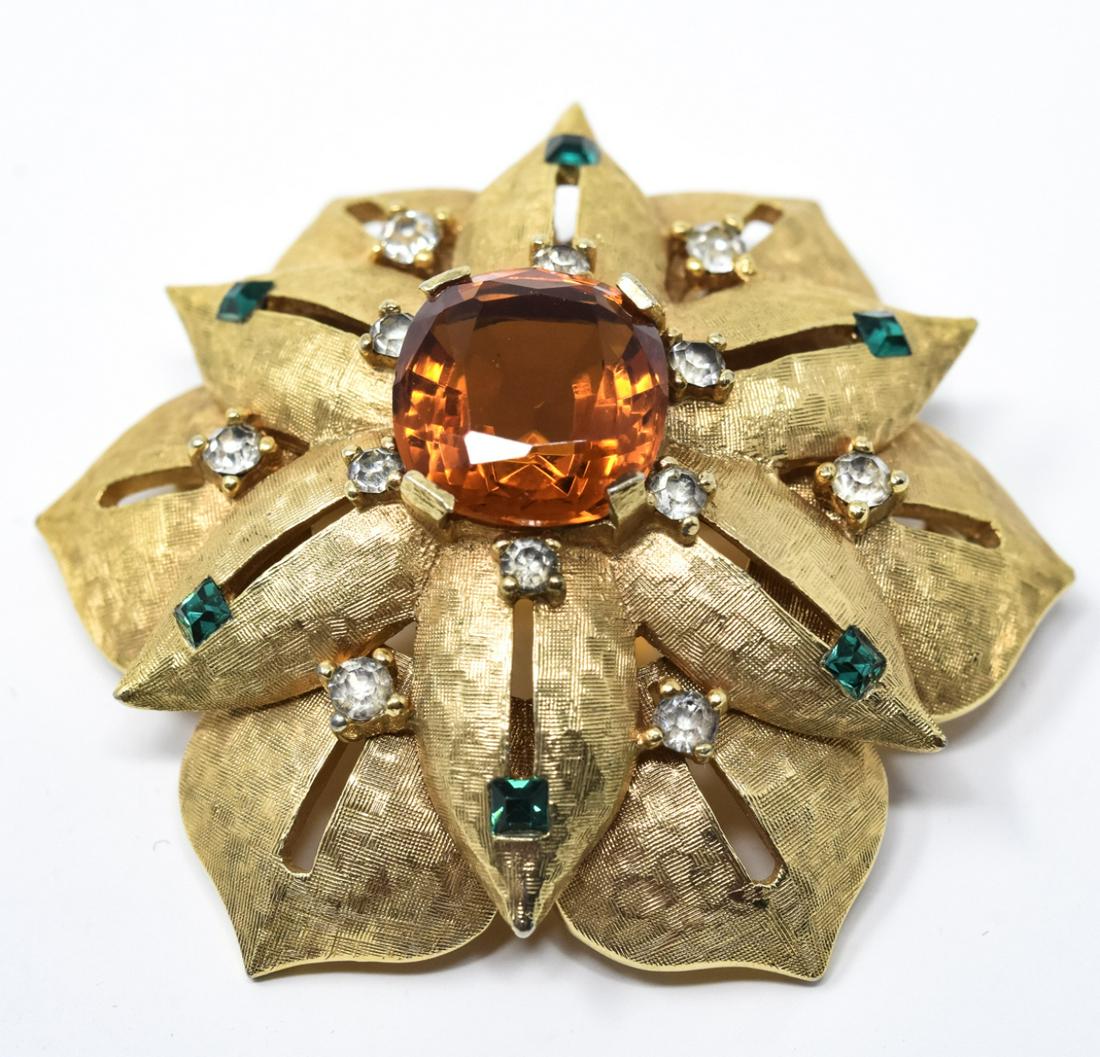 C 1970s Vintage Jomaz Gilt Metal Brooch: C 1970s Vintage Jomaz Gilt Metal Brooch. Signed. Two tier design with citrine tone, emerald tone and clear rhinestones. Made in the Buccellati style. Measures 2 inches in diameter.