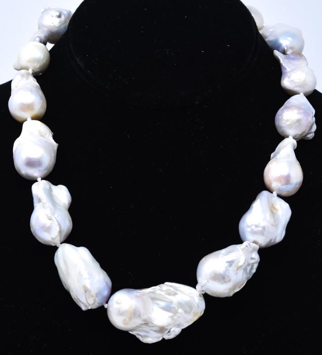 Hand Knotted Large Baroque Pearl Necklace Strand: Hand Knotted Large Baroque Pearl Necklace Strand. Featuring large scale graduated size cultured baroque pearls from Vietnam. Hand knotted on white silk thread. Largest pearl measures 39 mm in length. 