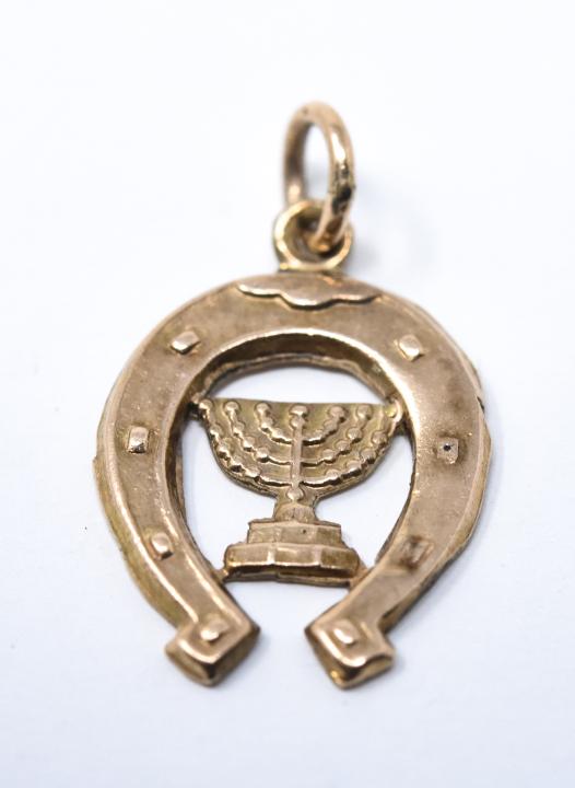 Vintage 14k Gold Horseshoe & Menorah Charm: Vintage 14k Horseshoe and Menorah Charm – Acid tested for 14k and approximately 11mm x 13mm. Unsold stock used for display from a prominent Westchester jewelry shop.
