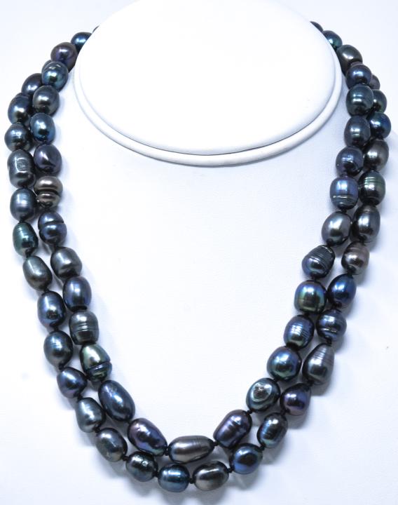 Pair of Hand Knotted Black Baroque Pearl Necklaces: Pair of Hand Knotted Black Baroque Pearl Necklaces. Tahitian type baroque pearls with tones of black, grey and silver. Hand knotted on black silver thread. Floral motif clasps. Each measures 18 inches