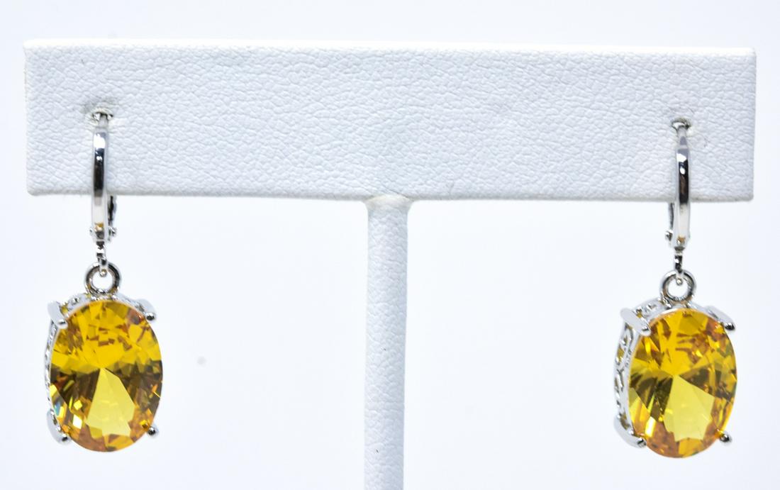 Pair of Oval Cut Yellow Morganite Earrings: Pair of Oval Cut Yellow Morganite Earrings. Stones are lab created. Each measures nearly 1.25 inches in length. Filigree settings.