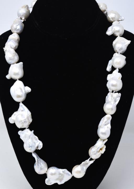 Impressive Cultured Baroque Pearl Necklace Strand: Impressive Cultured Baroque Pearl Necklace Strand. Hand knotted on white silk thread with graduated size pearls. Measures 25 inches in length. Largest pearl is approximately 30mm in length. Pearls are