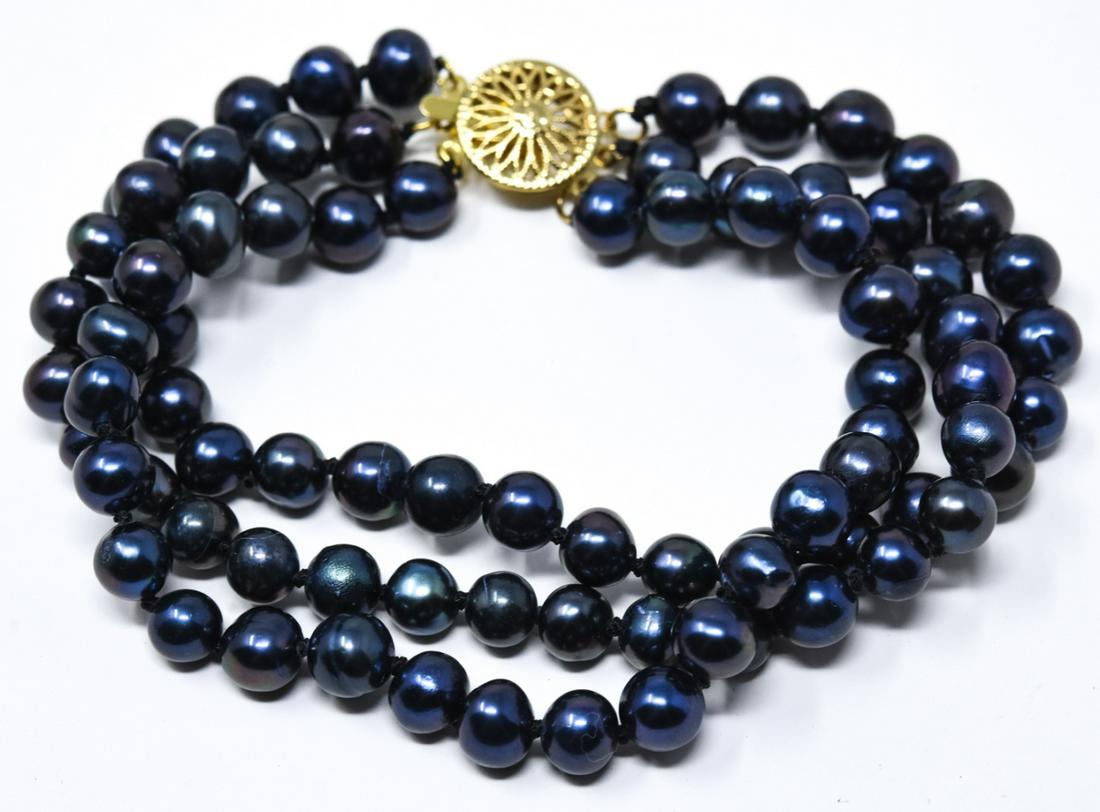 3 Strand Black Tahitian Baroque Pearl Bracelet: 3 Strand Black Tahitian Baroque Pearl Bracelet w Large Flower Motif Filigree Clasp. Hand knotted. Measures 7.75 inches in length.