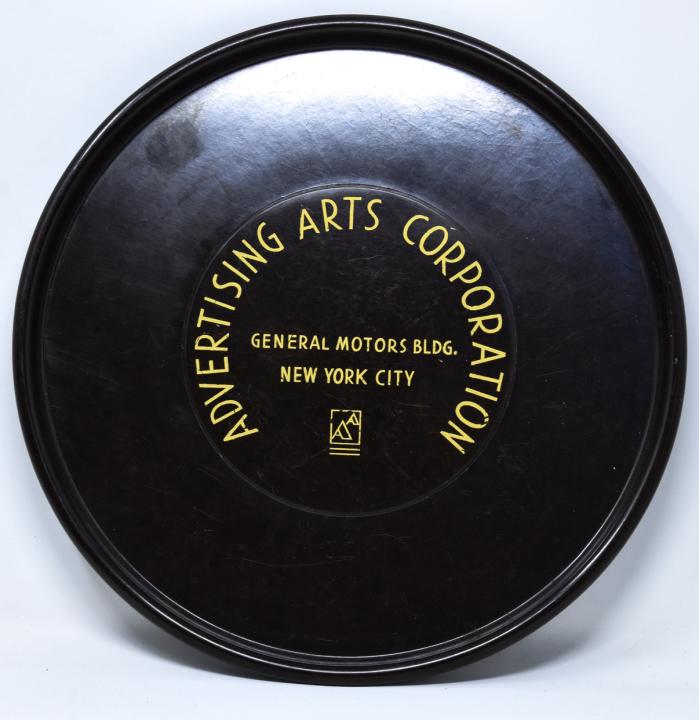 C 1930s Advertising Arts Corporation Bakelite Tray: C 1930s Advertising Arts Corporation Bakelite Tray. Bakelite tray for the Advertising Arts Corporation, General Motors Building, New York City. Measures 11.75 inches in diameter.