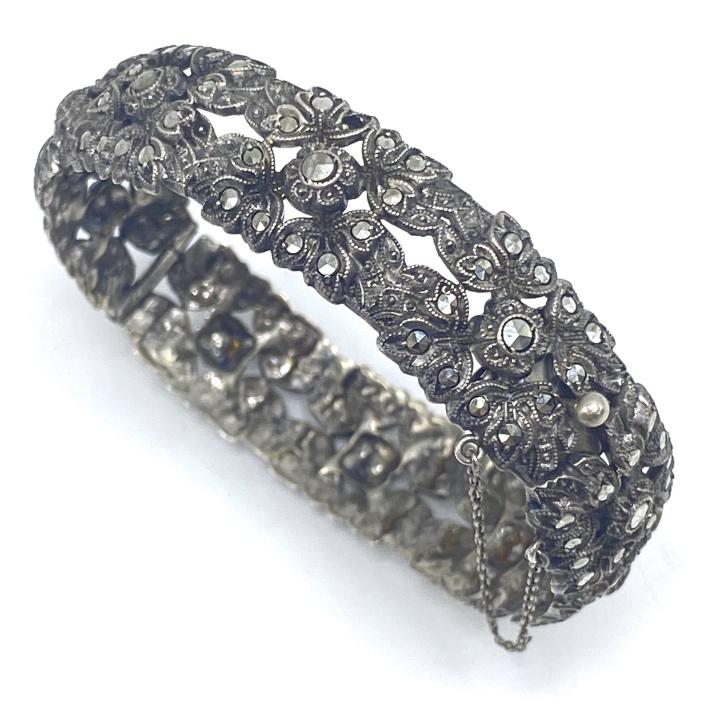 Antique Sterling Siver & Marcasite Bracelet: Antique Sterling and Marcasite Bracelet – This is a lovely antique or vintage piece. It is hinges and includes a safety chain. Approximately .625 inches wide and 29.4 grams inclusive.