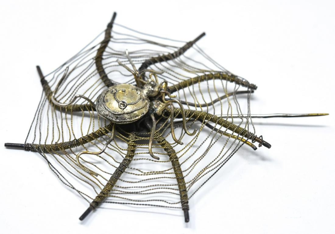 VA Handmade Silver Spider in Web Design Pin: Handmade Silver Spider in Web Design Pin. Measures 2.5 inches x 2 inches.