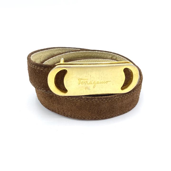Vintage Salvatore Ferragamo Brown Suede Belt: Vintage Salvatore Ferragamo Brown Suede Belt – Approximately .75” wide. Signed on the buckle and Salvatore Ferragamo Fierenze on the suede belt. There is some illegible handwriting by the buckle.