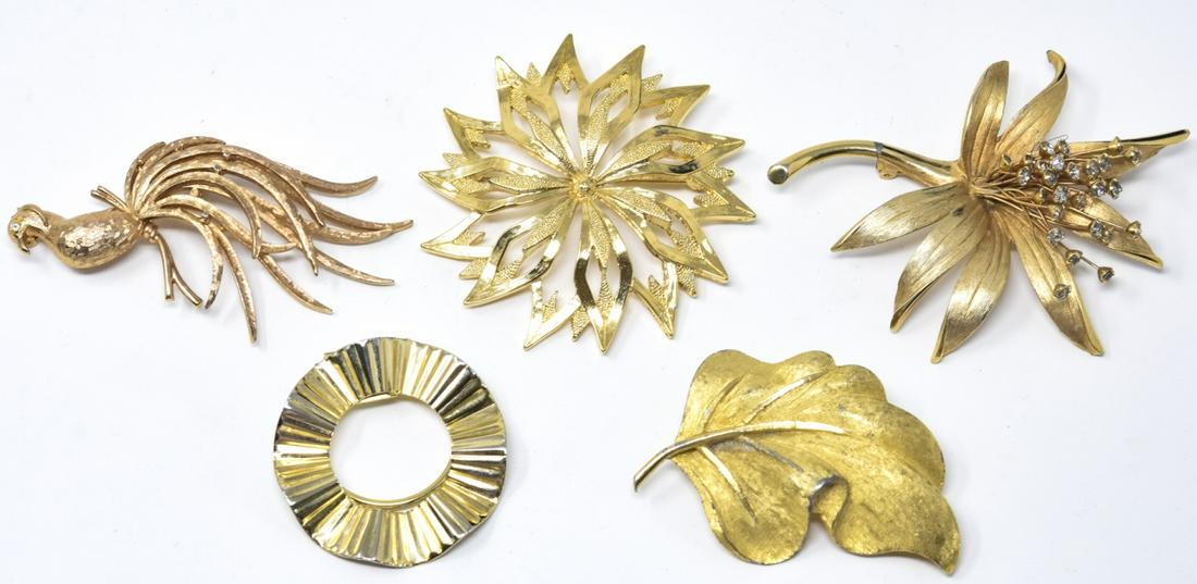 Five Costume Jewelry Signed Designer Brooch Pins: Five Costume Jewelry Signed Designer Brooches / Pins. Includes a wreath, bird, flower, leaf and starburst. Each is signed. Starburst is MONET and measures 2.5 inches in diameter.