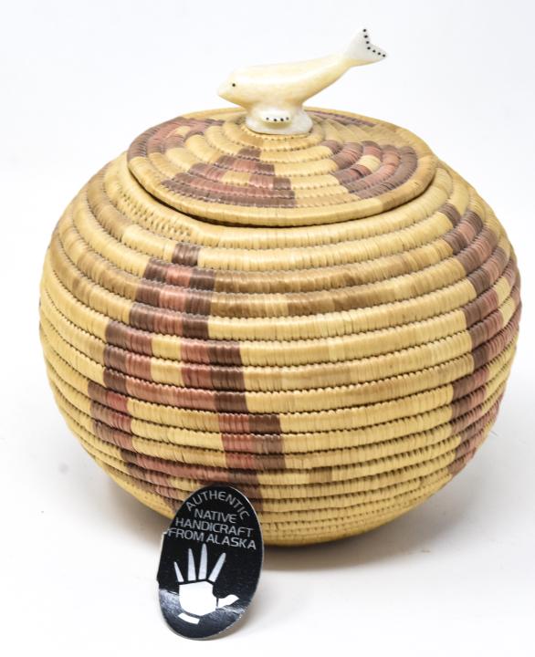 Margaret Wassillie Yupik Eskimo Artist Basket: Margaret Wassillie Yupik Eskimo Artist Basket w Carved Bone Finial of Whale. Measures 6 inches in height.