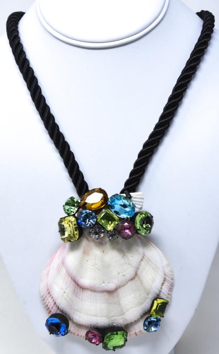 Vintage C 1980 Kenneth Lane Shell Necklace: Vintage C 1980 Kenneth Lane Shell Necklace. Large natural shell pendant with multicolored rhinestones on black braided cord which measures 22 inches. Pendant measures 4.25 inches.