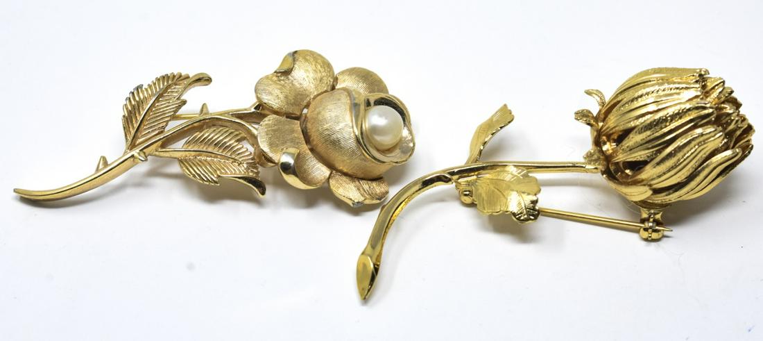 2 Trifari & Monet Gilt Floral Pins / Brooches: 2 Trifari & Monet Gilt Floral Pins / Brooches. Both pins are signed. Trifari measures 2.5 inches in width.