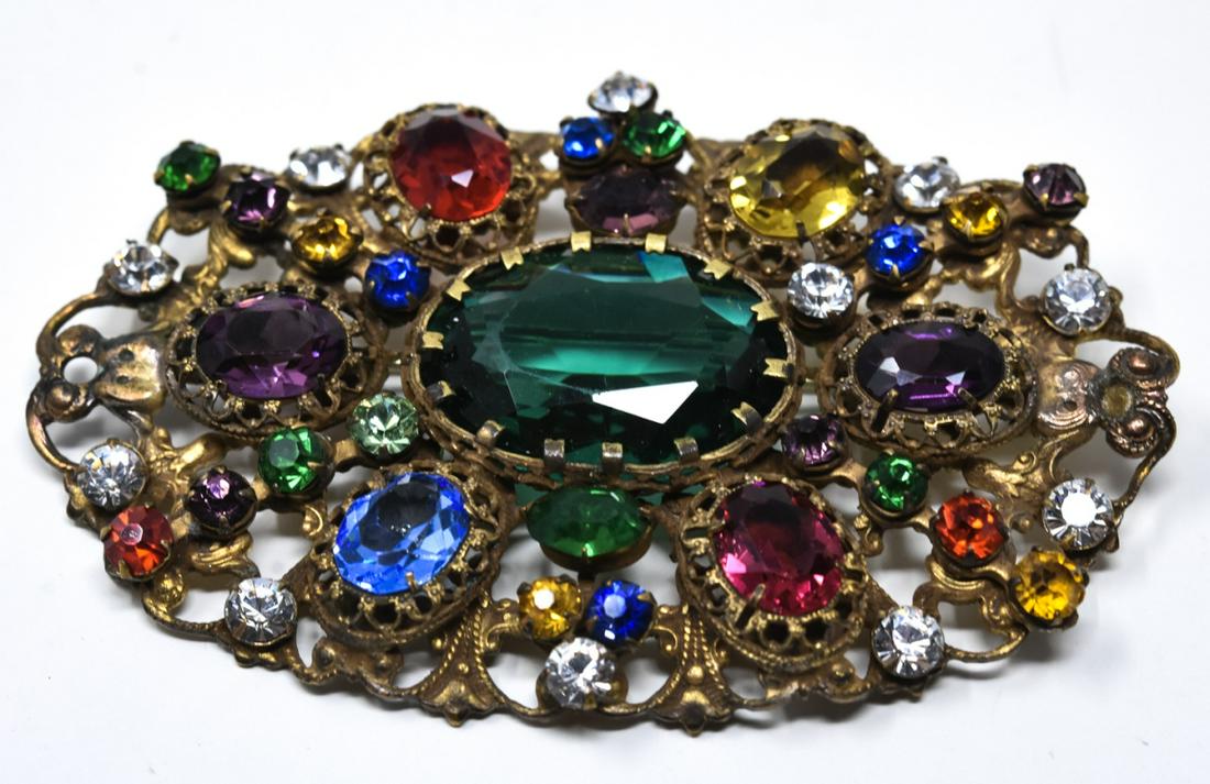 C 1930 Czech Multicolor Crystal Brooch / Pin: C 1930 Czech Multicolor Crystal Brooch / Pin. Czech brooch featuring open work oval design with multi color oval and round prong set crystals. Measures 3 1/8 inches in width.