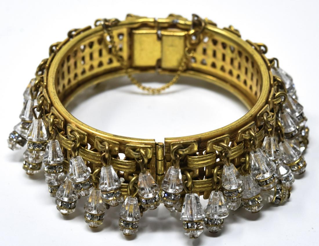 Miriam Haskell Gilt Clear Bead Bangle Bracelet: Miriam Haskell Gilt Clear Bead Bangle Bracelet. Gilt brick motif suspending clear faceted conical and round bead charms. Hallmarked. Measures 2.25 inches across the interior opening.
