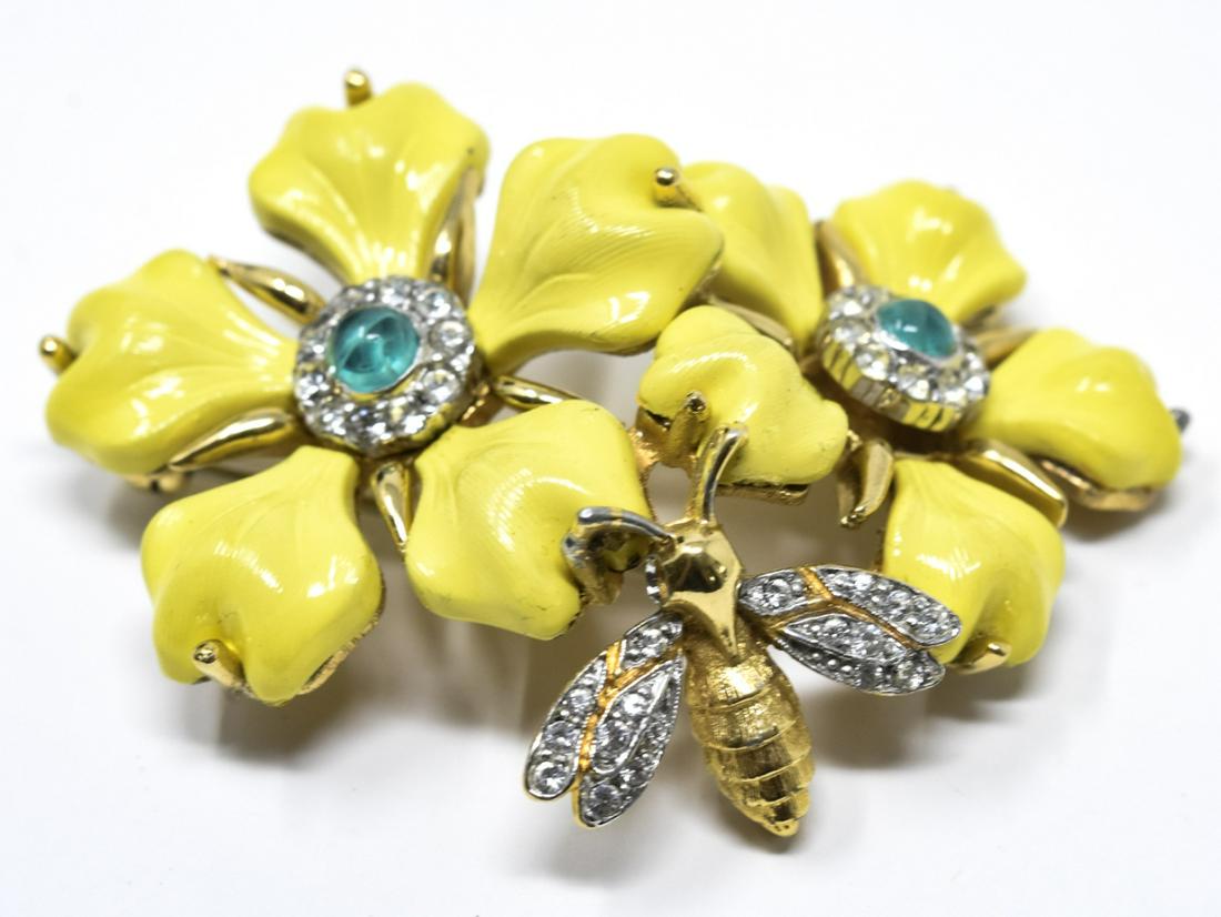C 1975 Jomaz Yellow Flower Brooch / Pin: C 1975 Jomaz Yellow Flower Brooch / Pin. With motif of two yellow glass petaled flowers with faux emerald cabochon cluster center and paste winged bee. Signed. Measures 2.25 inches.