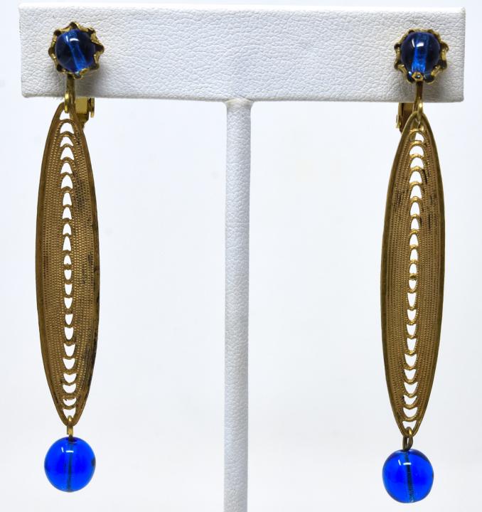 Pair of Vintage Miriam Haskell Clip on Earrings: Pair of Vintage Miriam Haskell Clip on Earrings. Gilt filigree and sapphire tone art glass beads. Each measures 2.75 inches in length.