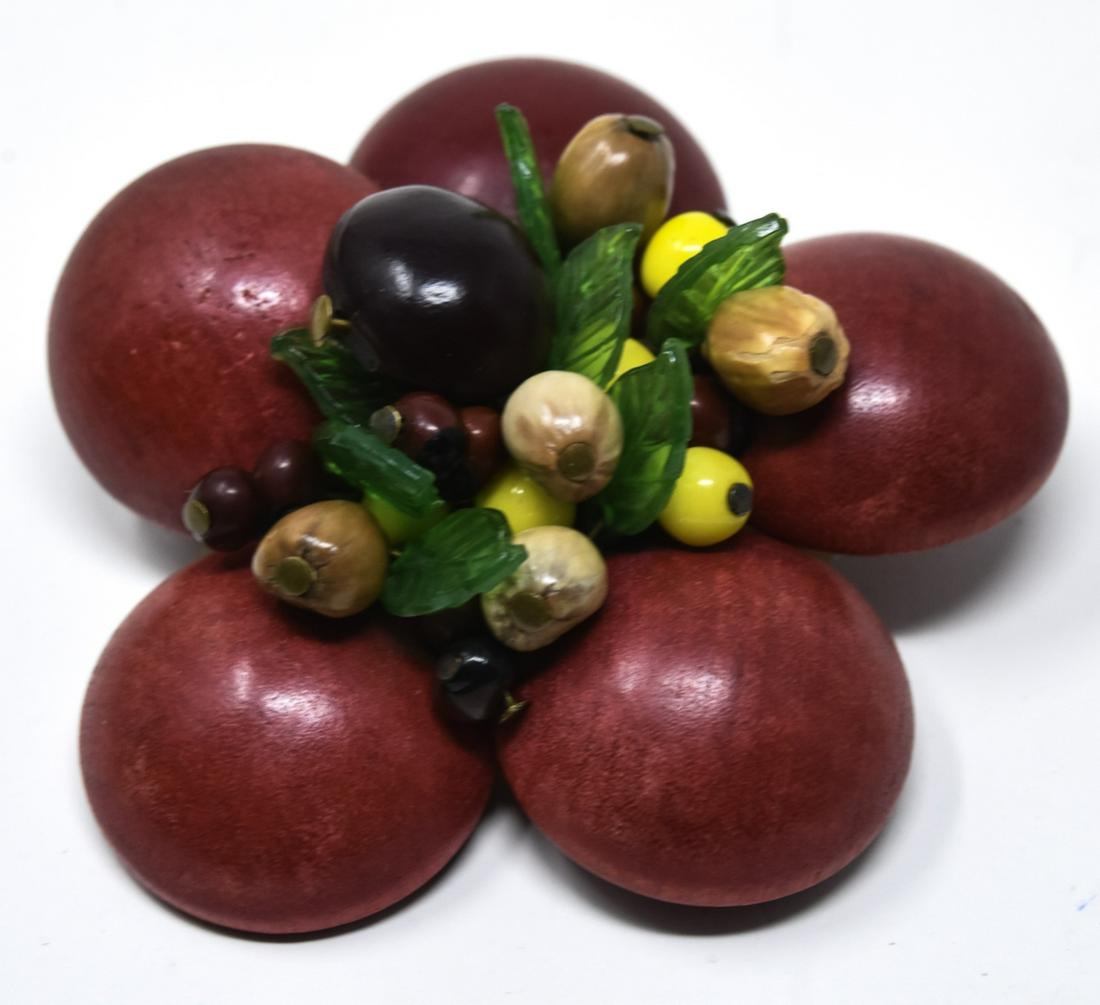 Vintage Early Design Brooch by Miriam Haskell: Vintage Early Design Brooch by Miriam Haskell. Unsigned but identified as Miriam Haskell. Wood, glass, etc. Measures 2.5 inches in diameter.