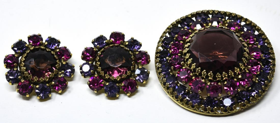 Vintage C 1965 Weiss Brooch & Clip on Earring Set: Vintage C 1965 Weiss Brooch & Clip on Earring Set. Gilt metal demi parure with pink and purple rhinestone paste. Brooch measures nearly 2 inches in diameter.