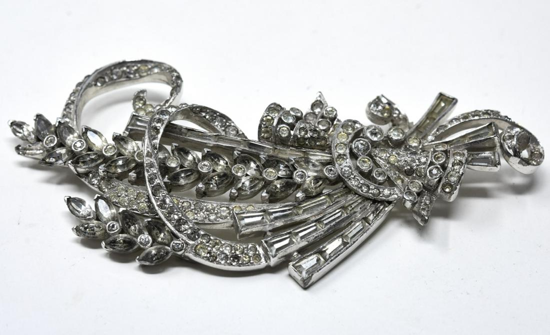 Mazer C 1940 Rhodium Bouquet of Flowers Brooch: Mazer C 1940 Rhodium Bouquet of Flowers Brooch. Rhodium bouquet of floral sprigs and ribbon swirls in clear paste with tapered baguettes. Signed. Measures 3.5 inches in width.
