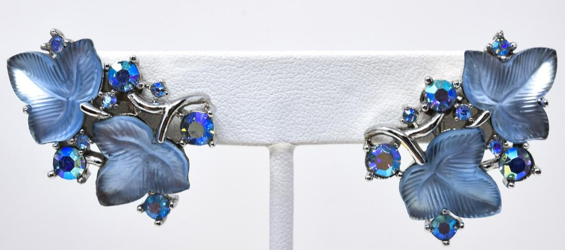 Pair Trifari Trefoil Stone Leaf Clip Earrings: Pair Trifari Trefoil Stone Leaf Clip Earrings. Pair clip earrings with carved trefoil stone leaves with rainbow paste accents in rhodium. Circa 1965. 1.5 inches. Signed.