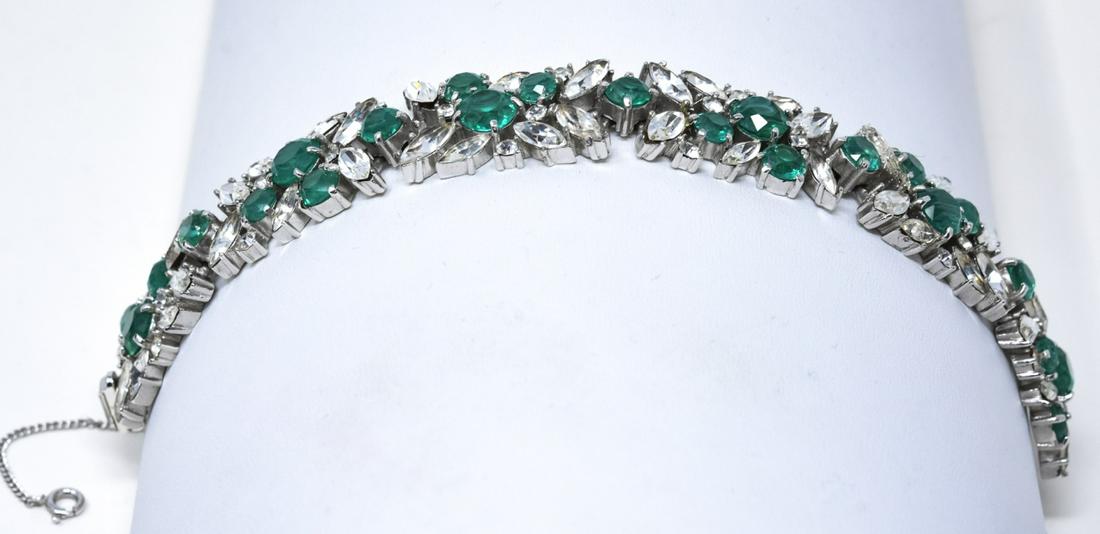 Trifari C 1970 Faux Emerald Rhodium Bracelet: Trifari C 1970 Faux Emerald Rhodium Bracelet. Wide prong set faux emeralds with round and marquise cut rhinestones. Measures 7 inches in length and 3/4 of an inch wide.