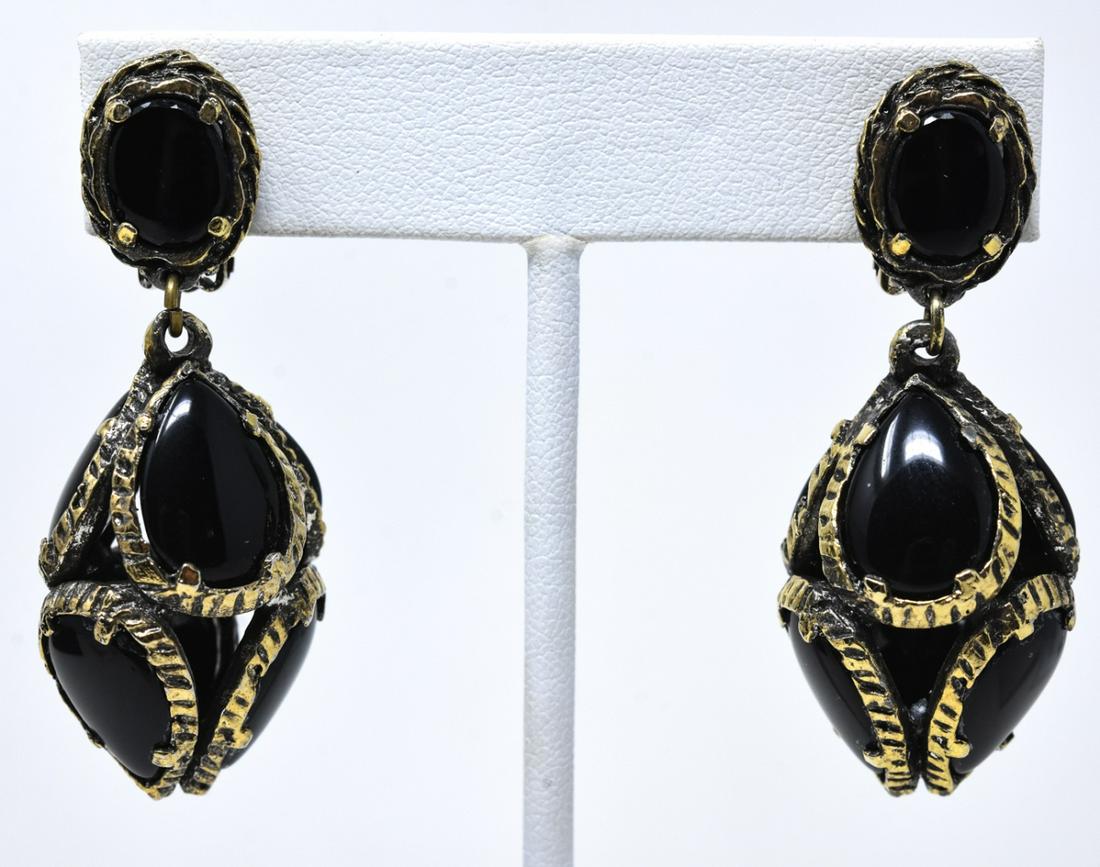 Pair Trifari C 1970s Antique Gilt Clip Earrings: Pair Trifari C 1970s Antique Gilt Clip Earrings. With black glass. Each measures 2 inches. Signed.