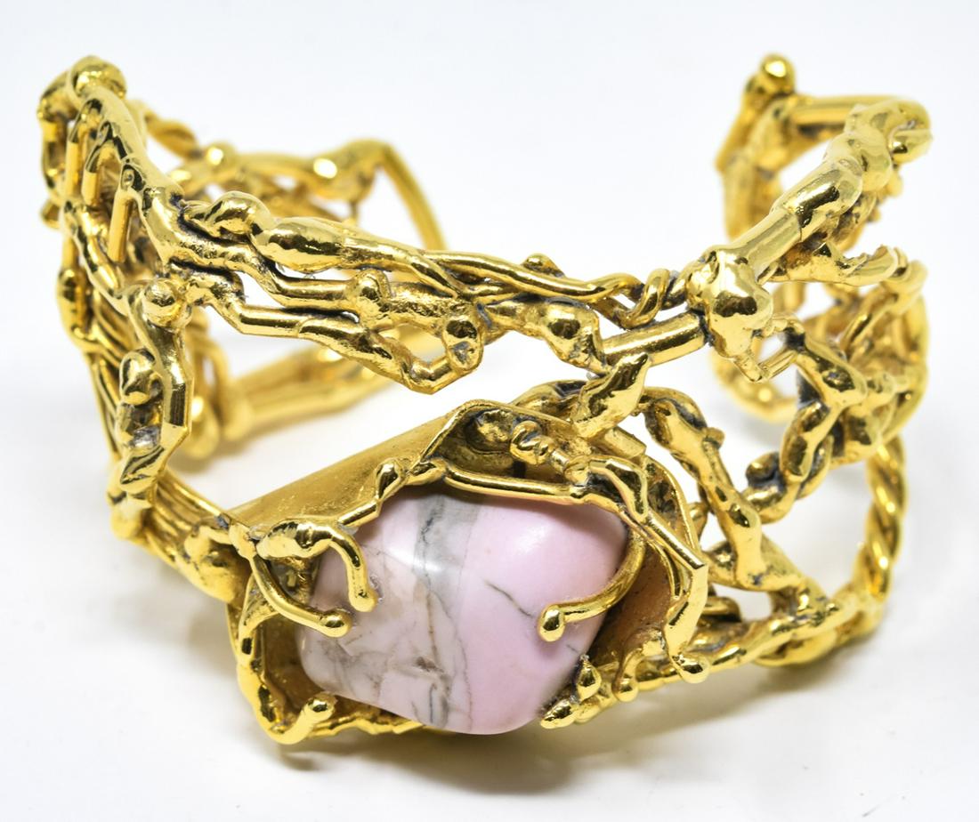 Abstract Modernist Gilt & Agate Cuff Bracelet: Abstract Modernist Gilt & Agate Cuff Bracelet. Gilt bracelet with abstract human figures and center pink agate. Measures 2.5 inches across the interior opening.