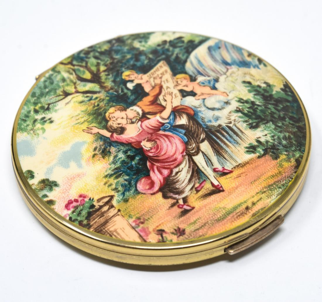 Stratton England Courtship Scene Ladies Compact: Stratton England Courtship Scene Ladies Compact. Rococo style courtship scene of boy and girl missing in a garden with cupids. Measures 2.75 inches.