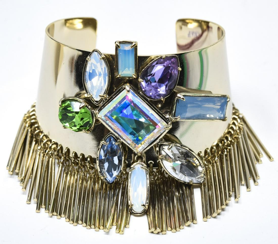 French Appartement A Lover Cuff Bracelet: French Appartement A Lover Cuff Bracelet. Signed on interior. Gilt cuff bracelet with jeweled center and bar tassels all around. Measures 2.5 inches across the interior opening.