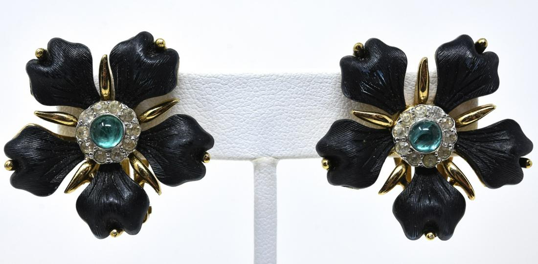 Pair Jomaz C 1970 Black Enamel Clip Earrings: Pair Jomaz C 1970 Black Enamel Clip Earrings Black enamel petals with gilt stamens and emerald cabochon paste halo center. Signed. Each measures 1.25 inches.