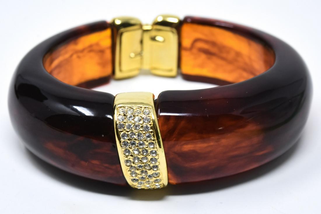 C 1990 Kenneth Lane Acrylic Clamper Bracelet: C 1990 Kenneth Lane Acrylic Clamper Bracelet. Tortoise acrylic bracelet with pave gilt panel accent. Measures 2.5 inches across the interior opening.