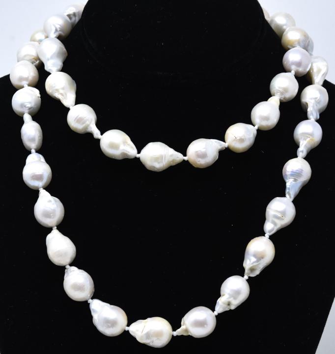 Impressive Cultured 15mm Baroque Pearl Necklace: Impressive Cultured 15mm Baroque Pearl Necklace. Hand knotted opera length cultured baroque pearl necklace strand. Pearls vary in size and average at 15mm. Measures 35 inches in length. Cultured pearl