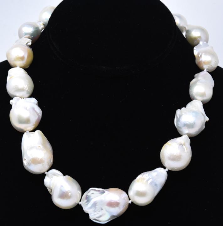 Large Baroque Cultured Pearl Hand Knotted Necklace: Large Baroque Cultured Pearl Hand Knotted Necklace. Hand knotted on white silk thread. High luster baroque pearls with iridescent tones of white, pink, champagne. Pearls vary in size from 15 to 25 mm 