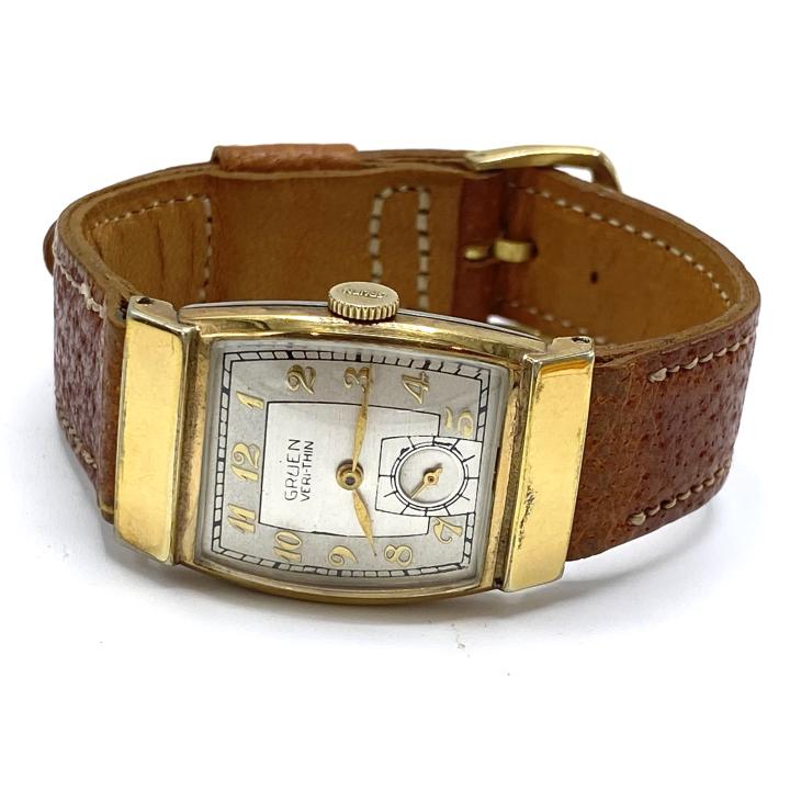 Antique Gruen Veri-Thin Watch: Antique Gruen Veri-Thin Watch – Manual with tan leather strap. Face is .875 x 1.375 inches. Strap is approximately .625 inches wide.
