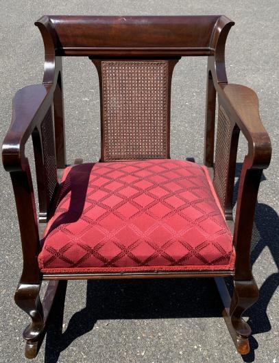 Mahogany Caned & Upholstered Rocking Chair: Mahogany Caned & Upholstered Rocking Chair. Mahogany rocking chair with caning and custom upholstered silk seat. Measures 32 inches x 27.5 inches x 37 inches.