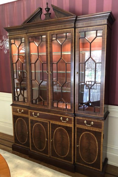 English Adams Brothers Glass Front Break Front: English Adams Brothers Glass Front Break Front. Book matched crotch mahogany with burled maple and fruit wood inlay. Broken arch pediment, paned glass doors, and dental trim with interior lighting. 87