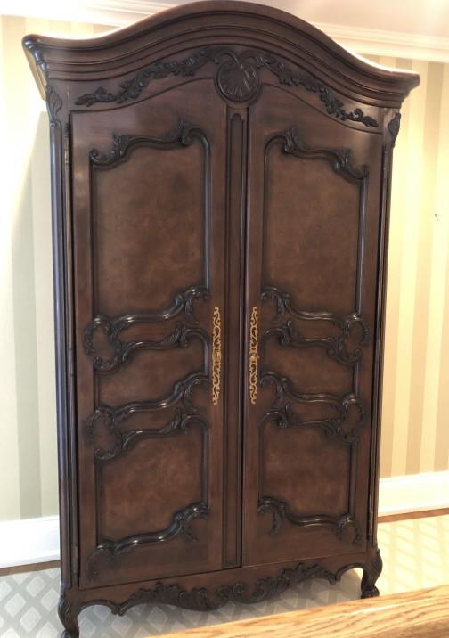 E.J. Victor French Country Carved Wardrobe: E.J. Victor French Country Carved Wardrobe. French Provencal Louis XIV style with Carved pediment, apron, legs and doors. Multiple drawers and shelves. Brass hardware. 86 inches x 48 inches x 23 inche