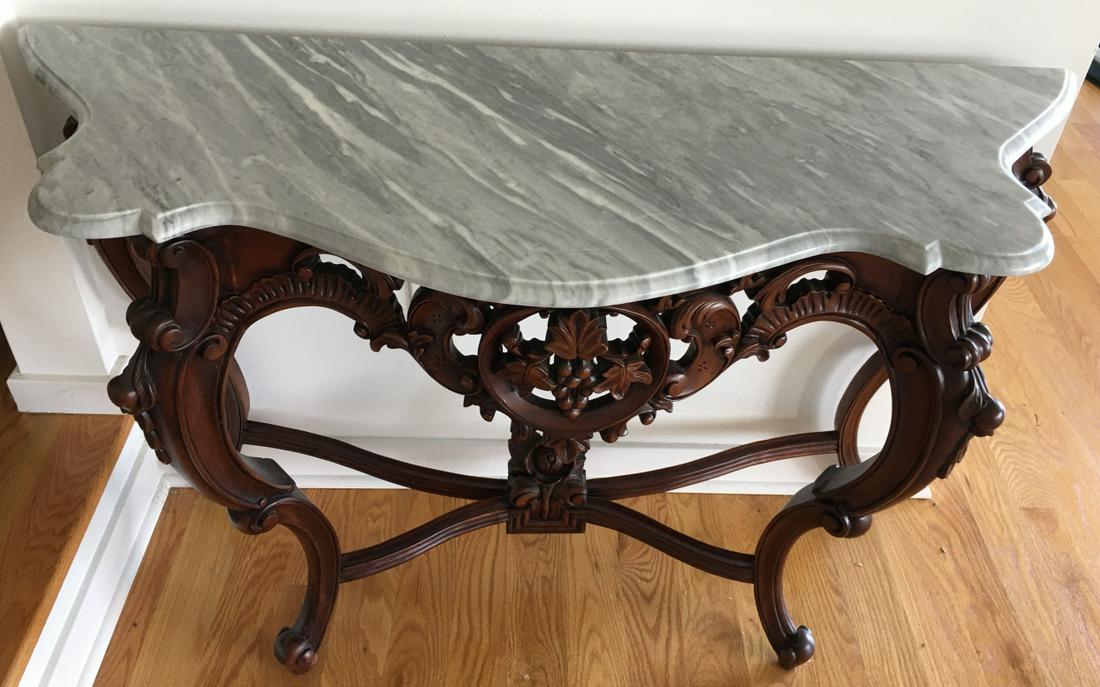 Heavily Carved Marble Top Console Table: Heavily Carved Marble Top Console Table. Console table with heavily carved base and marble top. Measures 30 inches x 44 inches x 18 inches.
