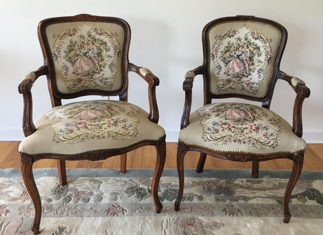 Pair Needlepoint Upholstered Arm Chairs: Pair Needlepoint Upholstered Arm Chairs. Pair of arm chairs with needlepoint upholstery depicting French Rococo courtship scenes. Each measures 36 inches x 22 inches x 18 inches.