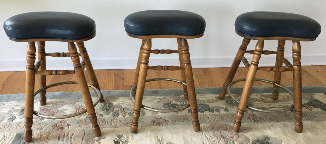 3 George B Bent & Co Leather Bar / Counter Stools: 3 George B Bent & Co Leather Bar / Counter Stools. Leather seats with spindle legs. Each measures 25 inches x 17 inches x 10 inches.