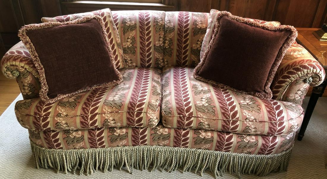 Custom Tapestry Upholstered Kidney Love Seat Trim: Custom Tapestry Upholstered Kidney Shaped Love Seat with Silk Fringe Trim in Red, Gold and Ivory. Lilly of the Valley Motif. Rolled arms. 27 inches x 70 inches x 38 inches