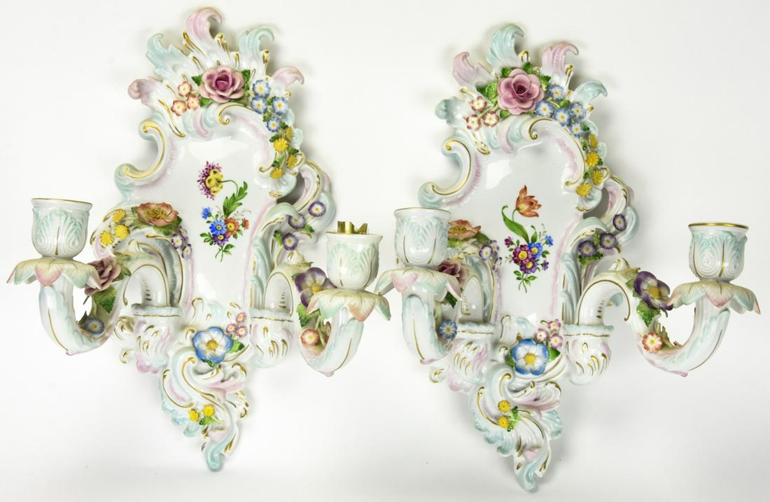 Pair Von Schierholz Germany Porcelain Wall Sconces: Pair Rococo Von Schierholz Germany Porcelain Wall Sconces. Rococo style cartouche-forms, each with two candle holders, applied and painted floral decoration, early 20th century. Height 16 inches x 11 