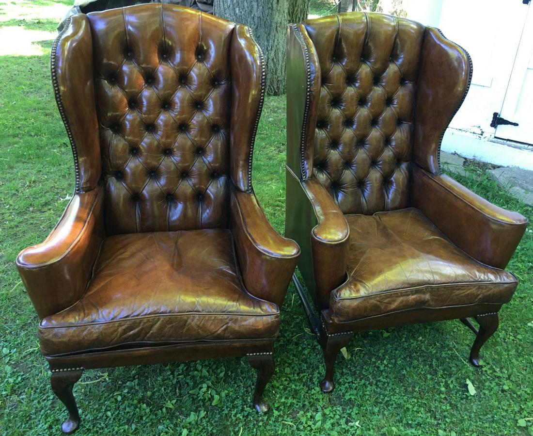 2 Chesterfield Style Tufted Leather Arm Chairs: 2 Chesterfield Style Tufted Leather Arm Chairs. High back arm chairs with tufted brown leather upholstery and nailhead trim. Each measures 45 inches x 31 inches x 30 inches.