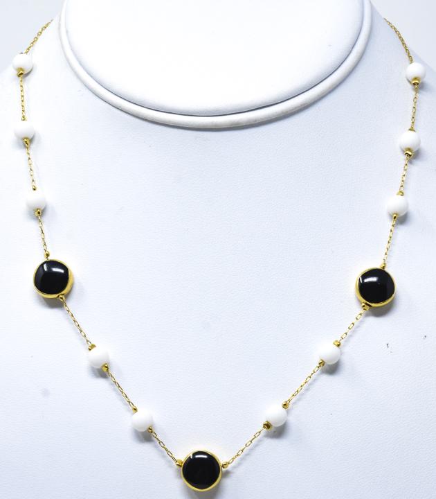 Vintage Monet Gold Tone Choker Necklace: Vintage Monet Gold Tone Choker Necklace. With black and white beads. Signed. Measures 17 inches.