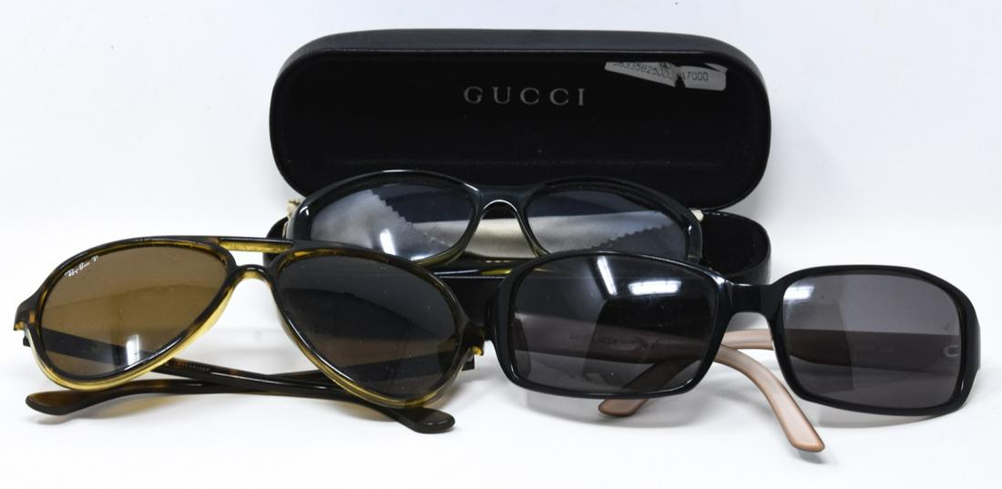 3 Pairs Designer Sunglasses Incl Gucci & Ray Ban: 3 Pairs Designer Sunglasses Incl Gucci & Ray Ban. Three pairs of plastic framed sunglasses, including Gucci, Ray Ban and Kate Spade. Gucci case measures 6 inches x 2.5 inches.