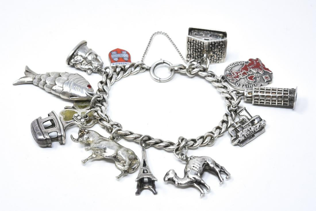 Sterling Silver Charm Bracelet W Charms: Sterling Silver Charm Bracelet W Charms. Sterling silver charm bracelet with charms of varying silver content. Some are hallmarked sterling, 800 silver and 900 silver. Charms include articulated fish,