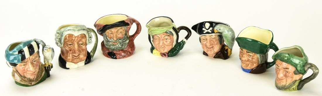 7 Royal Doulton Small Size Porcelain Toby Mugs: Royal Doulton Small Size Porcelain Toby Mugs. Mugs include Falstaff, Toby Philpors, Falconer, Auld Mac, Lawyer, Long John Silver, Sairey Gamp. Approximately 2 inches x 2 inches