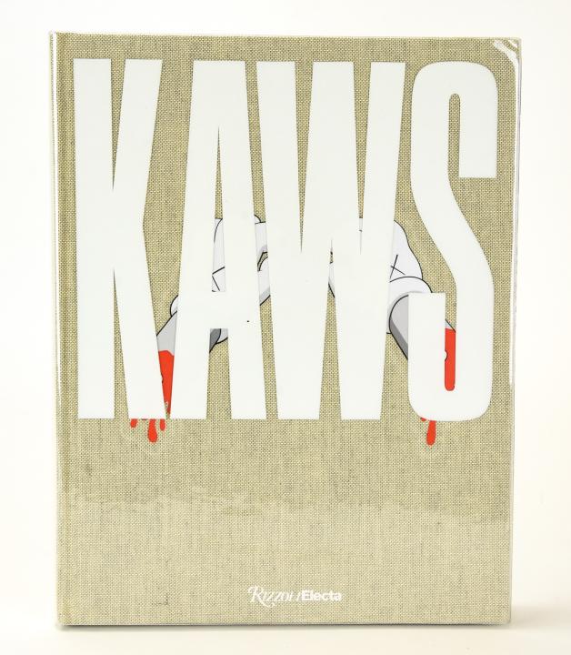 KAWS Rizzoli Art Book Signed W Original Drawing: KAWS Rizzoli Art Book Signed W Original Drawing. KAWS hardcover art book by Rizzoli Electa surveying the work of Brian Donnelley aka KAWS. Signed and with original drawing. 11 inches x 8.75 inches.