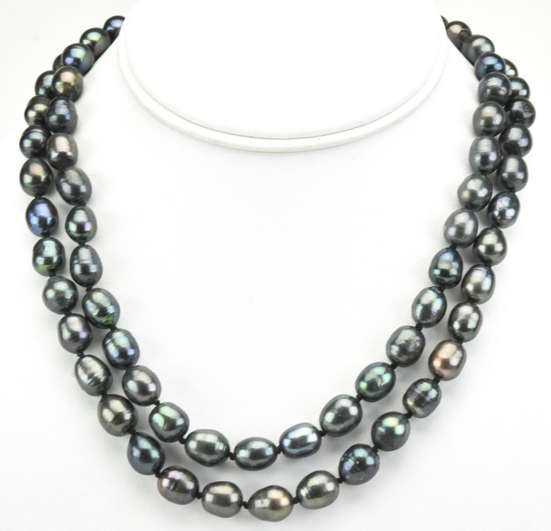 Pair Hand Knotted Black Tahitian Pearl Necklaces: Pair Hand Knotted Black Tahitian Pearl Necklaces. Hand knotted on black silk thread. Pearls have tones of black, gray, silver and are 9 to 10 mm in length. Filigree clasps. Each necklace measures 18 i